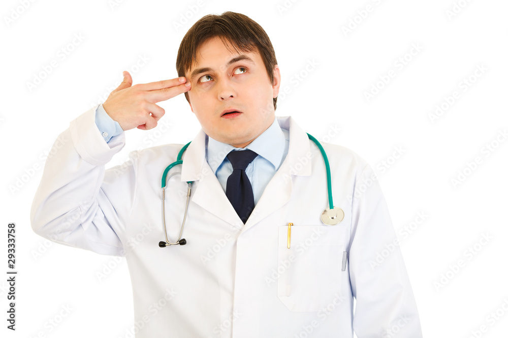 Stressed medical doctor with gun shaped hand isolated Stressed medical doctor with gun shaped hand isolated