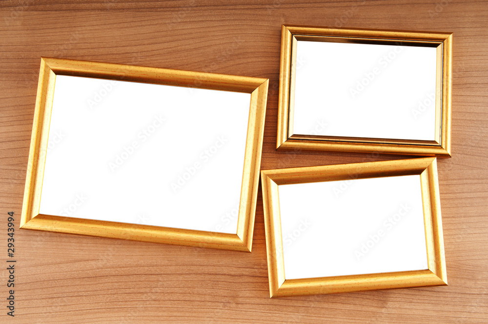 Picture frames on the polished wooden background Picture frames on the polished wooden background