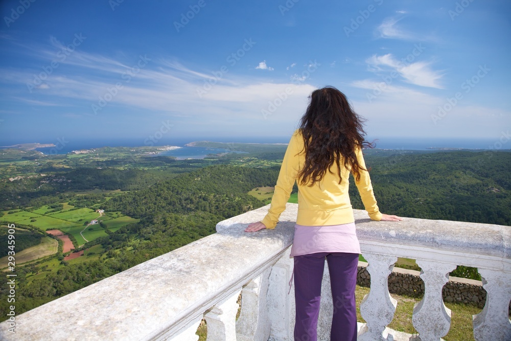 woman yellow pullover watching ocean woman yellow pullover watching ocean