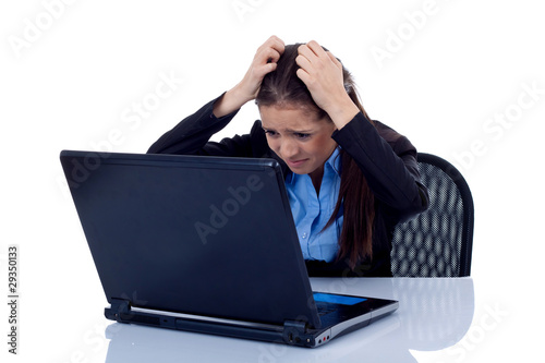 business woman reading bad news at laptop