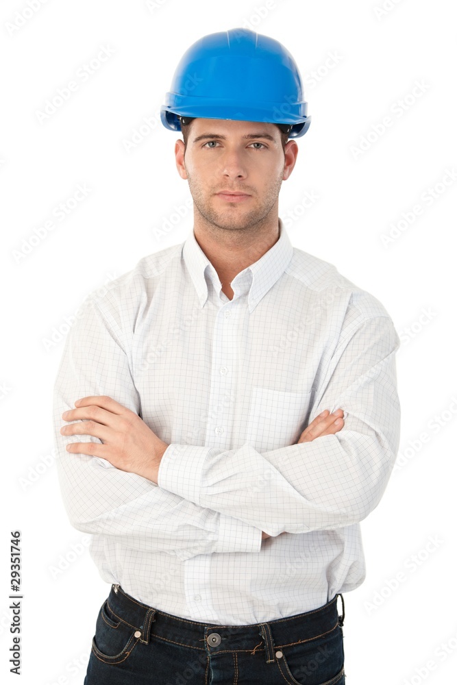 Goodlooking young architect standing arms crossed Goodlooking young architect standing arms crossed