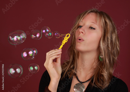 woman blowing soap bubble