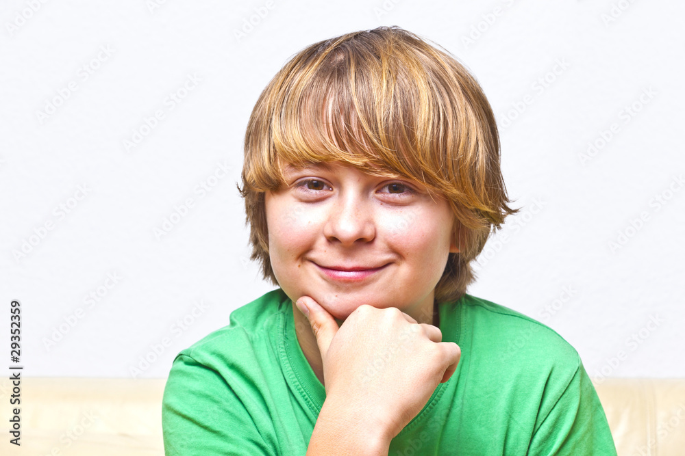 smiling boy sitting on a sofa smiling boy sitting on a sofa