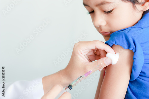 Boy and vaccine syringe photo