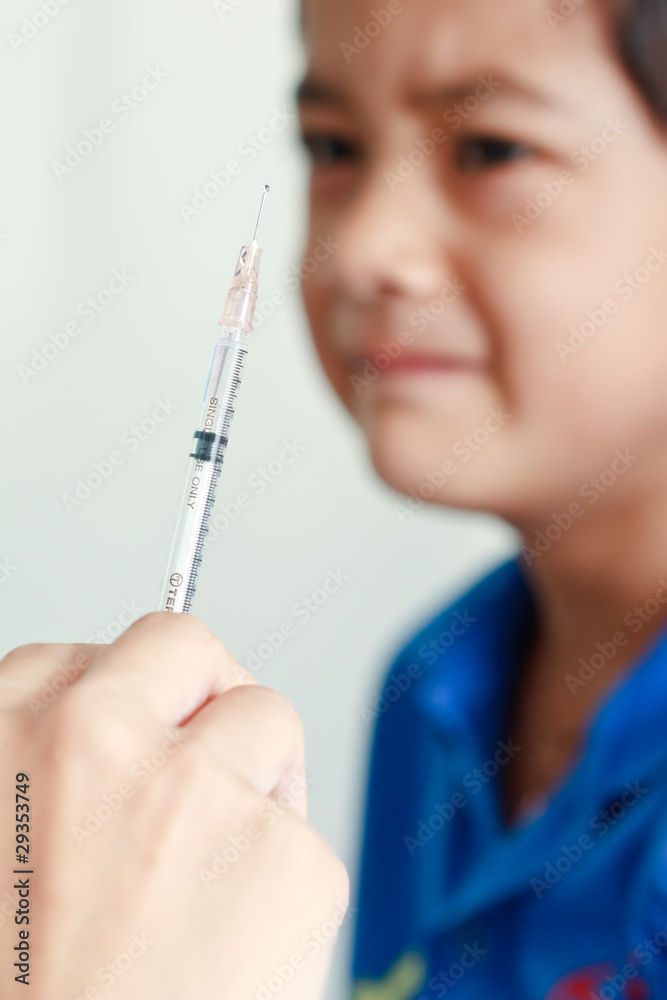Boy and vaccine syringe Boy and vaccine syringe