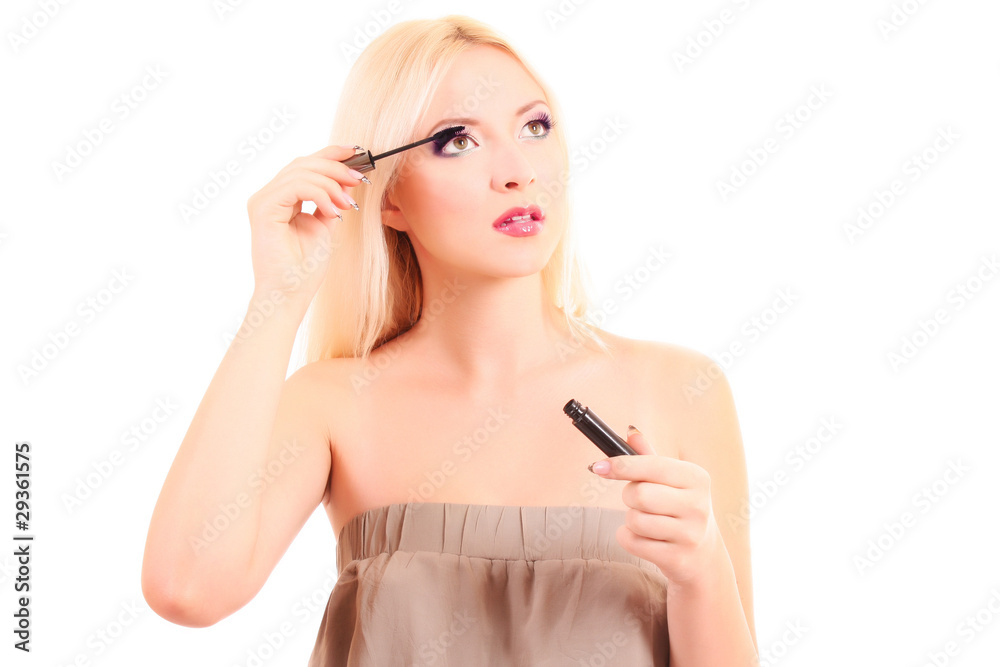 portrait of a young pretty blonde woman applying mascara portrait of a young pretty blonde woman applying mascara