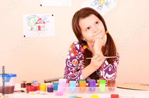 young and cute little girl painting a picture