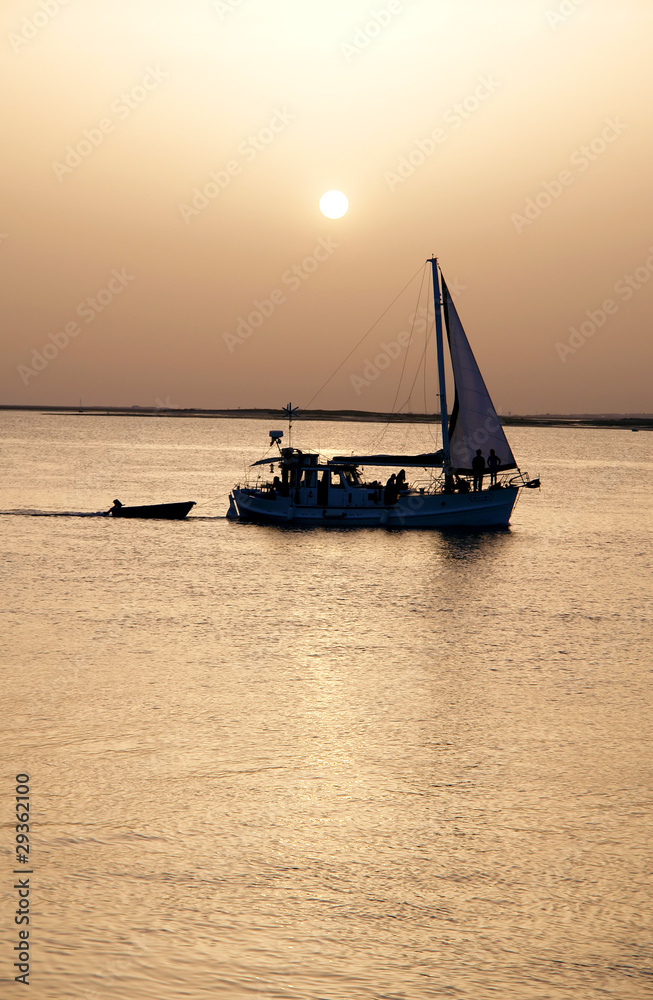 Fototapeta premium Recreation boat at sunset, in Ria Formosa, natural conservation