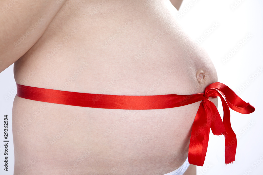 Pregnant belly with red ribbon. Nine month. Third trimester. Pregnant belly with red ribbon. Nine month. Third trimester.