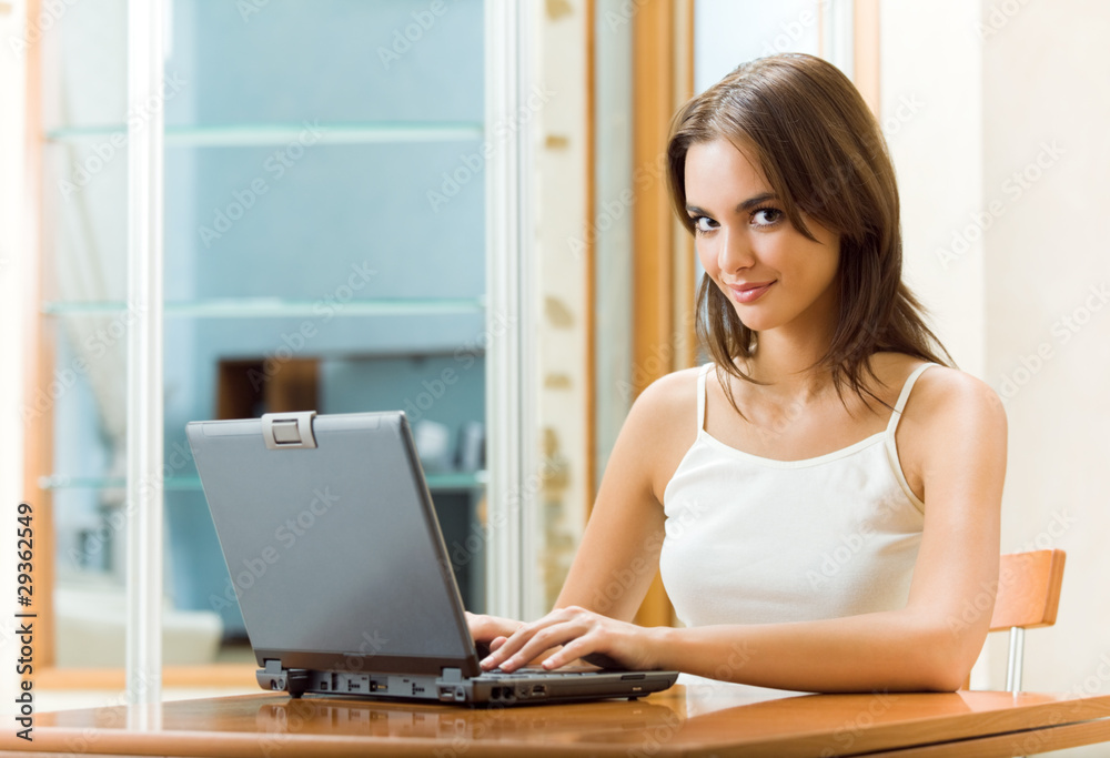 Portrait of young happy smiling woman working with laptop Portrait of young happy smiling woman working with laptop