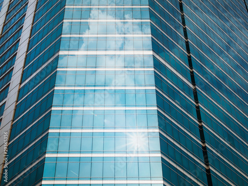 Glass of modern buildings and sky reflect