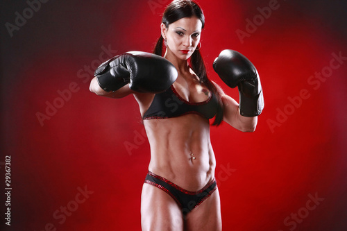 Fit female boxer swings a puch photo