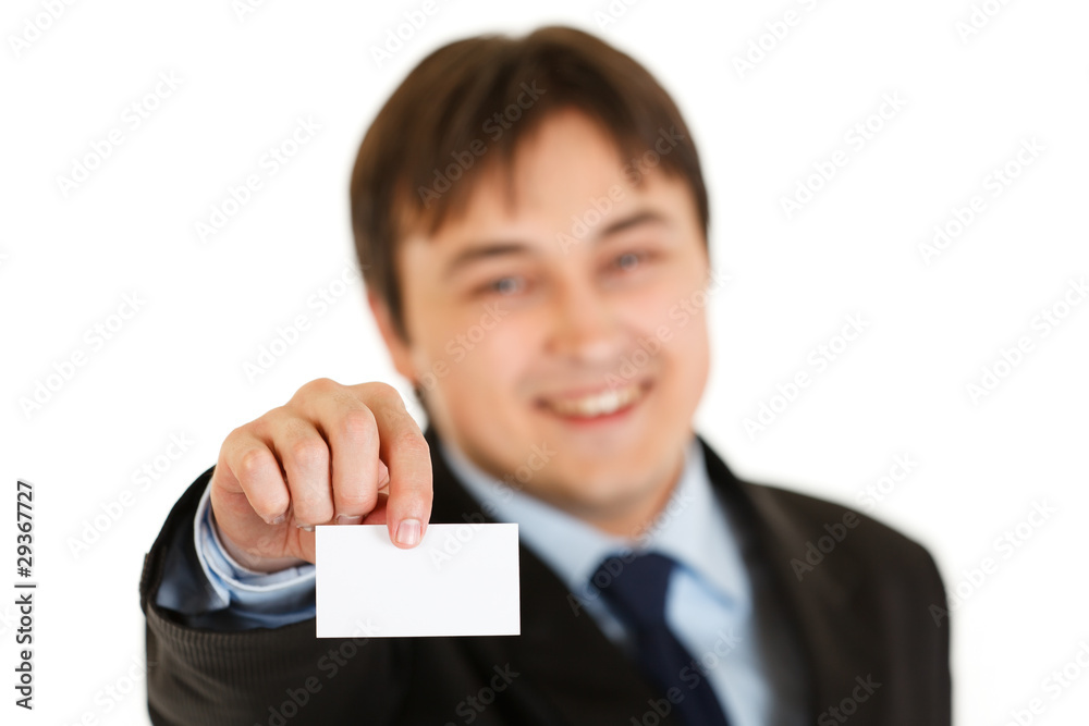 Smiling modern businessman holding blank business card Smiling modern businessman holding blank business card
