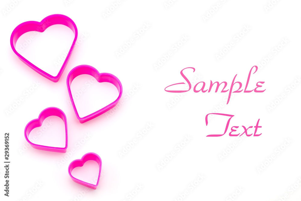 pink plastic pieces in heart shape isolated on white background