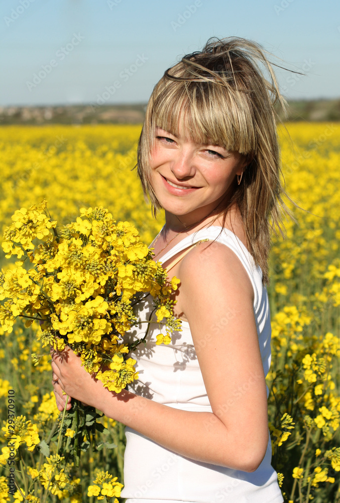 young beautiful woman on blooming field in summer young beautiful woman on blooming field in summer