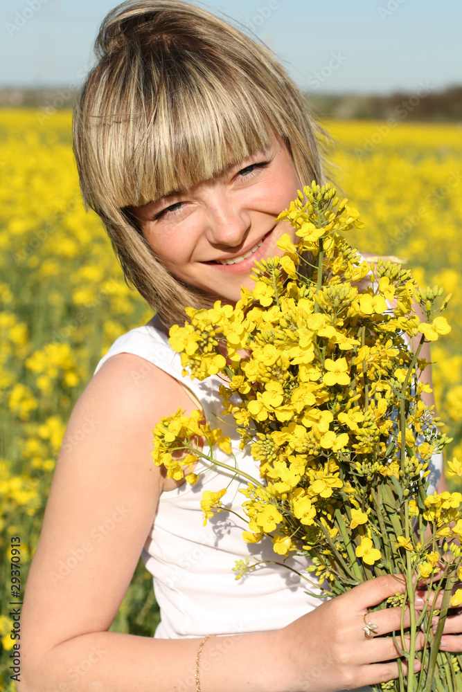 young beautiful woman on blooming field in summer young beautiful woman on blooming field in summer