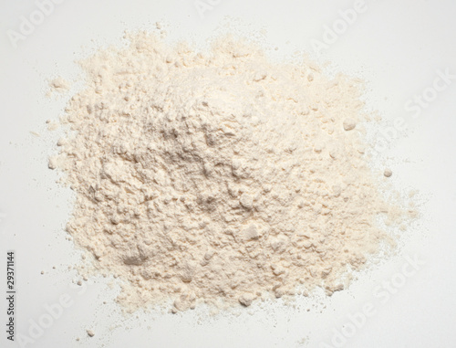 Wheat flour heap on a white background