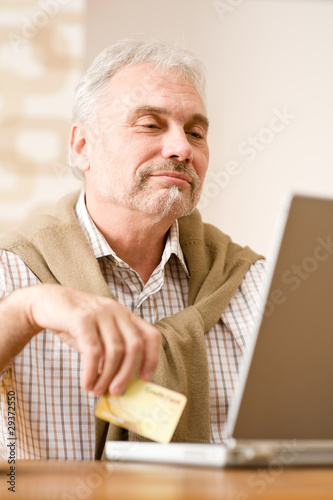 Senior mature man - home shopping with credit card