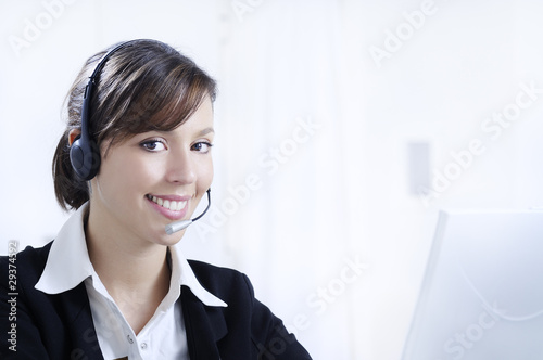 young woman in job; headphones and customer service
