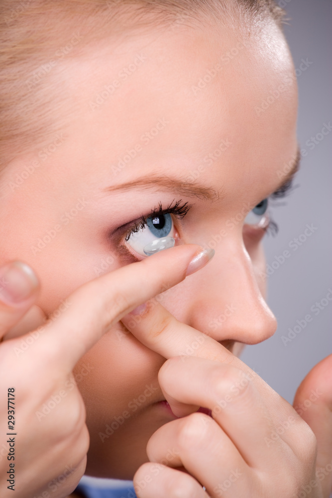 Fototapeta premium Inserting a contact lens