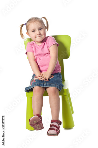little child sits on a chair
