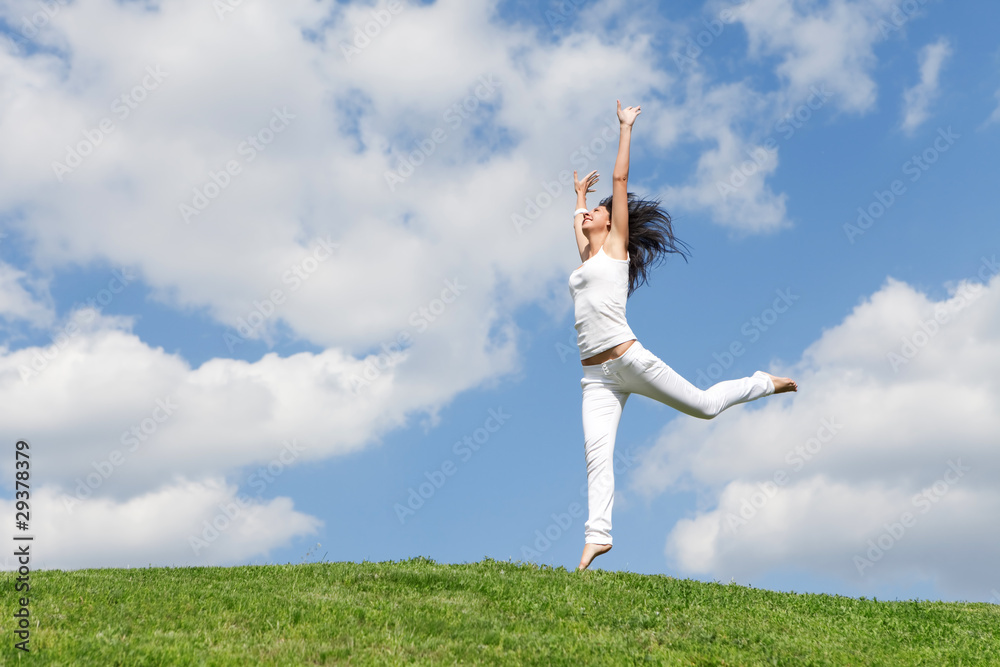 pretty young woman jumping on green grass pretty young woman jumping on green grass