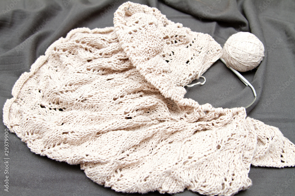 a beige knitted shawl with round needles a beige knitted shawl with round needles
