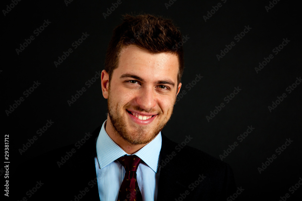 Smiling successful businessman on dark background Smiling successful businessman on dark background