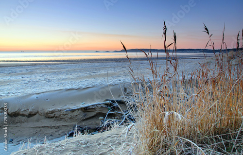 Frosty sunrise on Swansea beach (UK)
