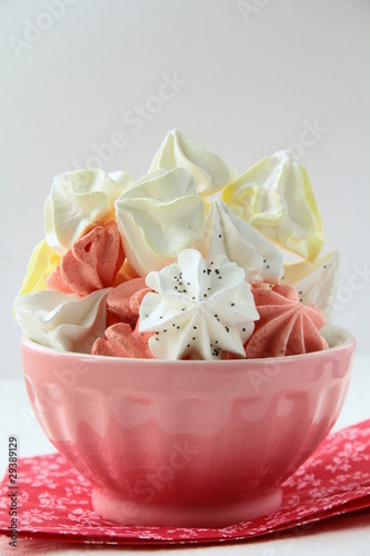 colorful meringue beze cookies in a cup on the table photo