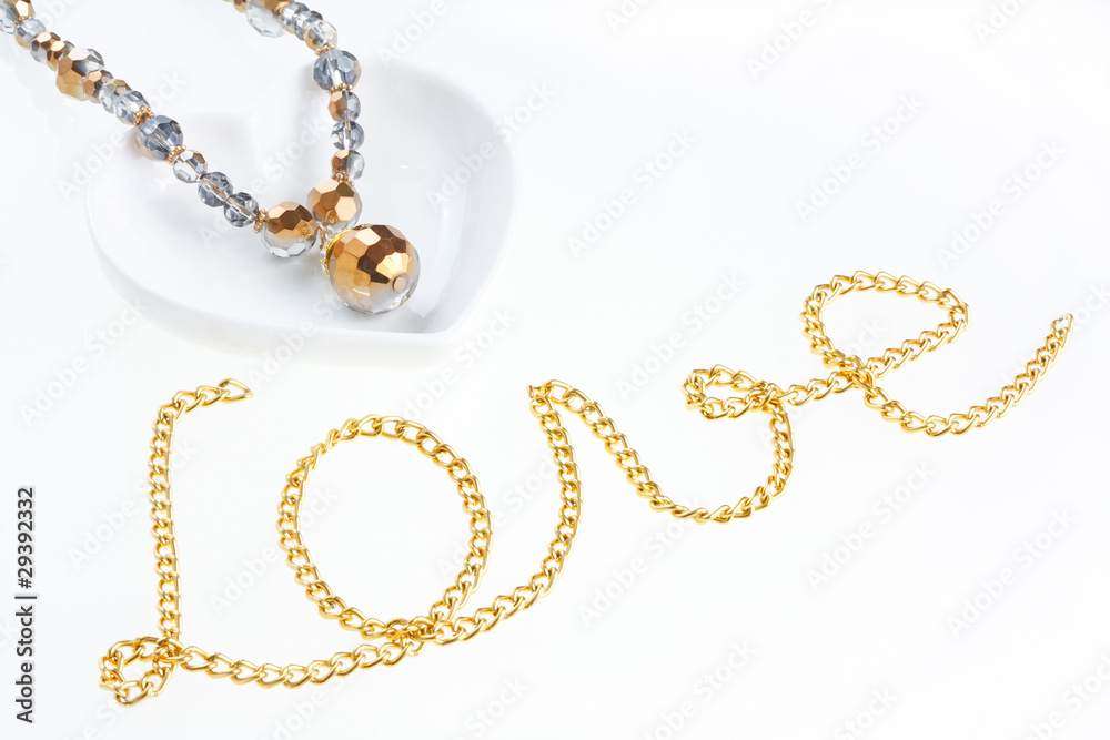 Jewel necklace on heart shaped saucer and yellow metal chain Jewel necklace on heart shaped saucer and yellow metal chain