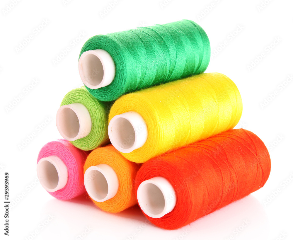 Pyramid of many-coloured bobbins of thread isolated on white Pyramid of many-coloured bobbins of thread isolated on white