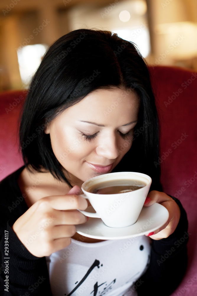 young woman sitting in a cafe drinking coffee young woman sitting in a cafe drinking coffee