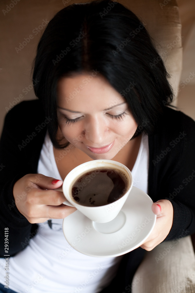 young woman sitting in a cafe drinking coffee young woman sitting in a cafe drinking coffee