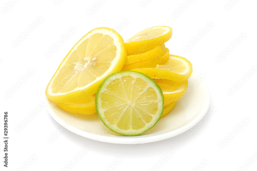 Sliced Lemon And Lime on Plate Isolated on White Background Sliced Lemon And Lime on Plate Isolated on White Background