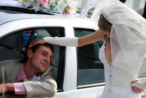 Bride and groom. Groom in the car