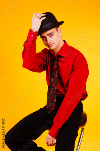 man in a hat on a yellow background