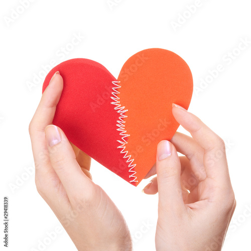 Valentine's day heart stitched from two halves in woman's hands