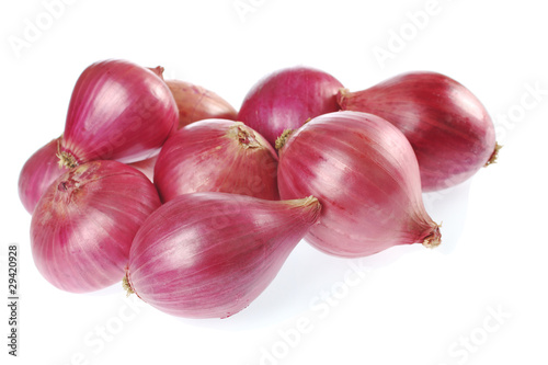 Several raw red onions on white