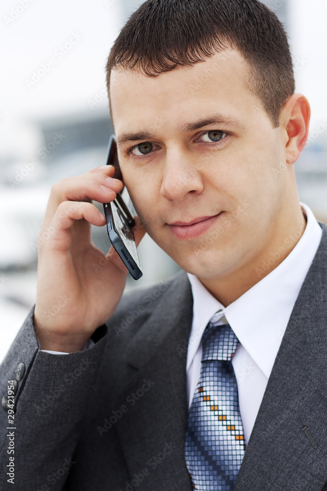 Successful young businessman talking on the phone Successful young businessman talking on the phone