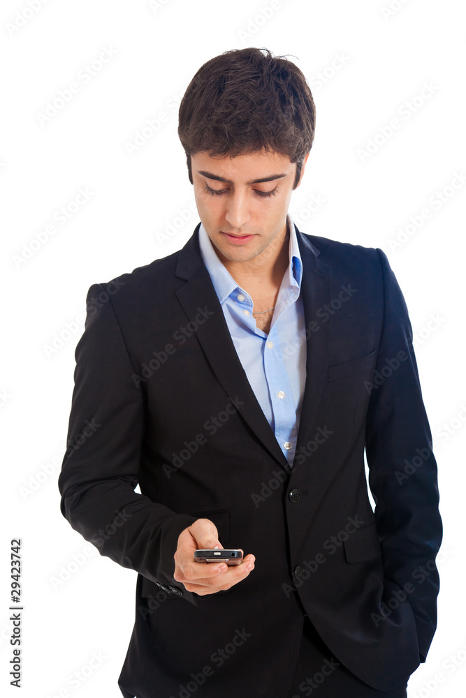 Young businessman sending a sms isolated on white