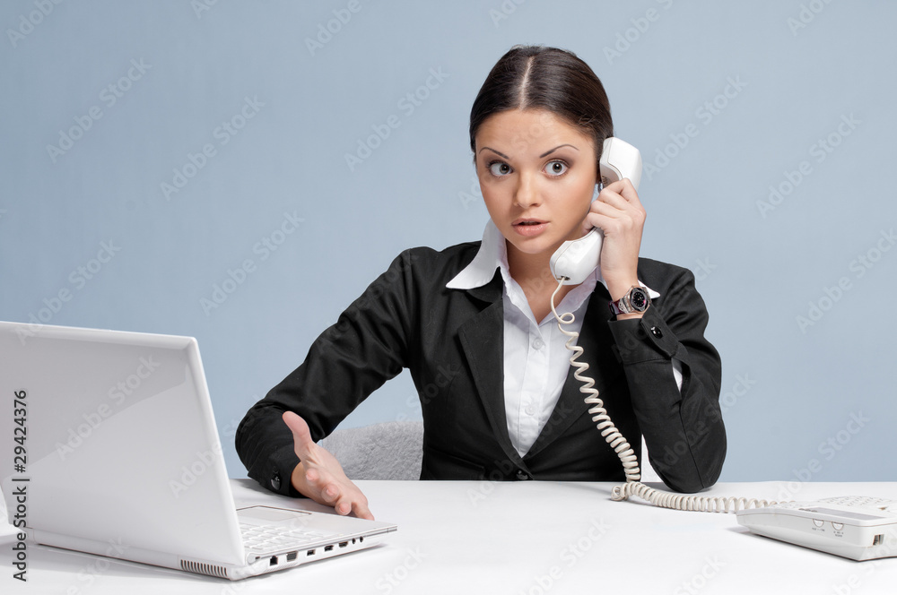Casual business woman in office talking by phone Casual business woman in office talking by phone