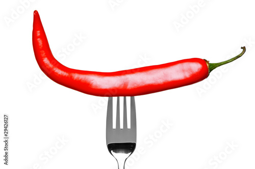 Red Chilli pepper on a fork isolated on white