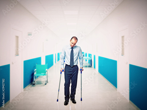 man with crutch in hospital