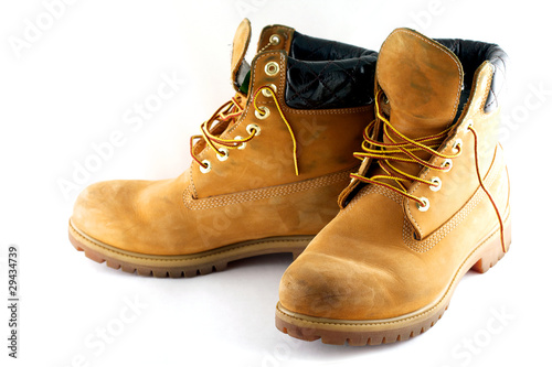 Pair of old yellow working boots Isolated on white background