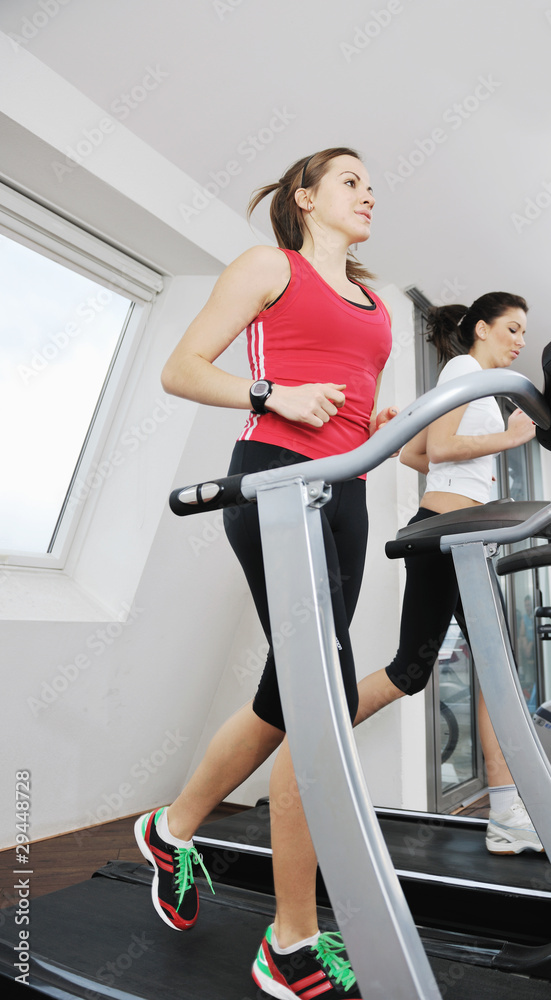 Fototapeta premium woman workout in fitness club on running track