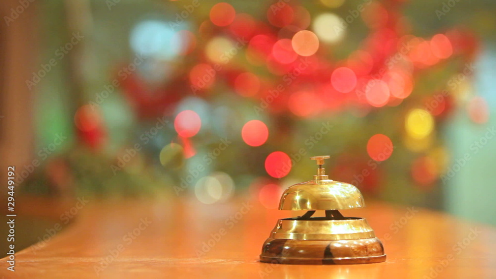 old hotel bell on a wood stand with very blurred background