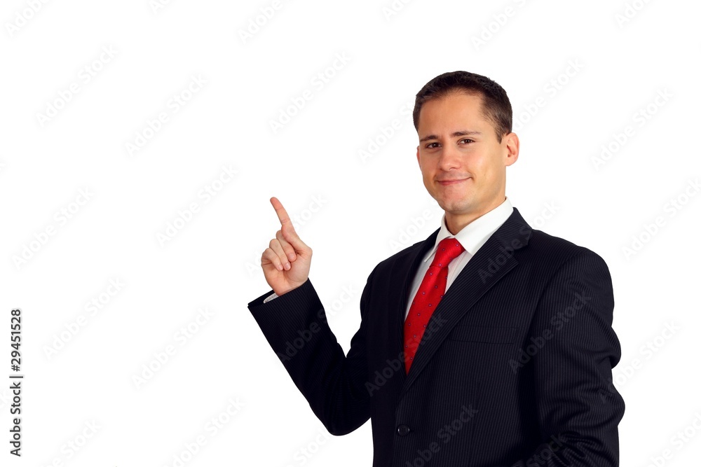 Handsome young man in a suit pointing up to his right side Stock