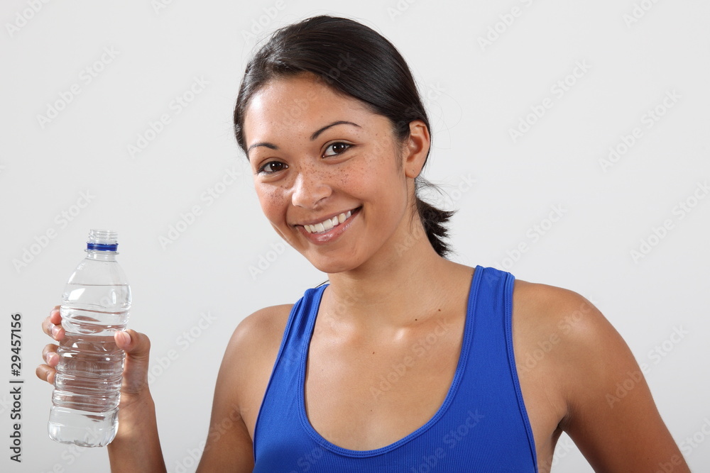Beautiful smiling young woman with bottled water Beautiful smiling young woman with bottled water