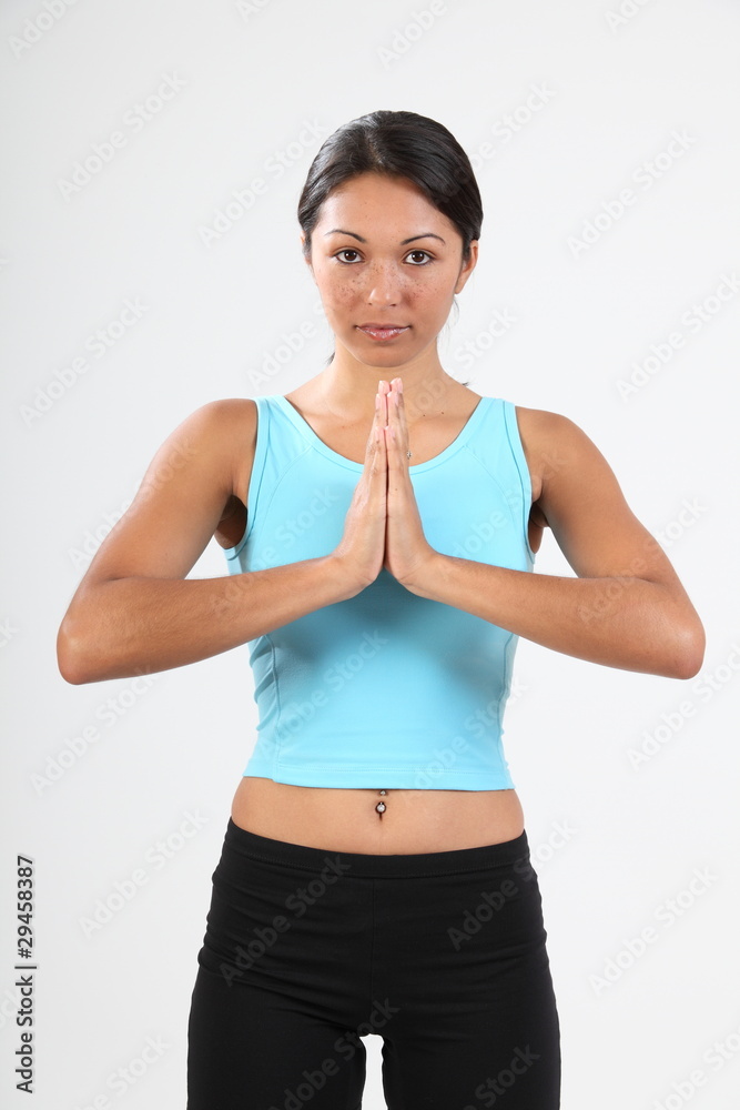 Beautiful young woman in calm meditating pose